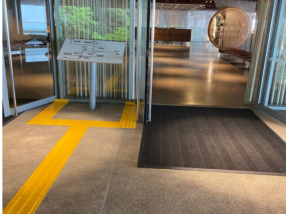 Aplicação de piso tátil direcional e mapa tátil, elemento essencial em um projeto de acessibilidade que garante orientação segura para pessoas com deficiência visual.