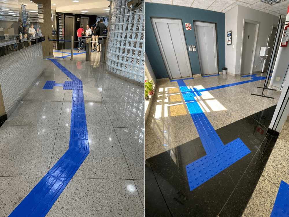 Piso tátil azul forma caminhos direcionais e áreas de alerta no chão de um edifício, orientando o deslocamento de pessoas com deficiência visual.